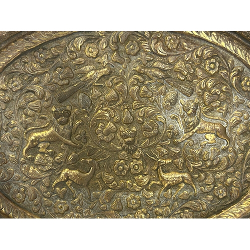 153 - A 19th century Persian gilded copper tray.Repousse decorated with animals amongst foliate design.36 ... 