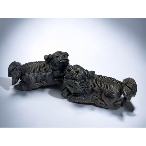 159 - A pair of Chinese carved wooden Fo dogs.Qing dynasty, 19th century.19 x 11cm