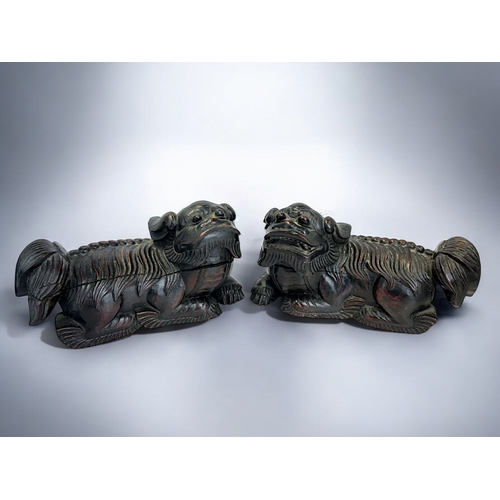 159 - A pair of Chinese carved wooden Fo dogs.Qing dynasty, 19th century.19 x 11cm