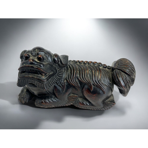 159 - A pair of Chinese carved wooden Fo dogs.Qing dynasty, 19th century.19 x 11cm