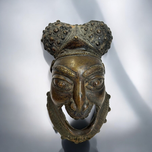 423 - A tribal Benin / Bamun people bronze wall hanging mask.19 x 10cm