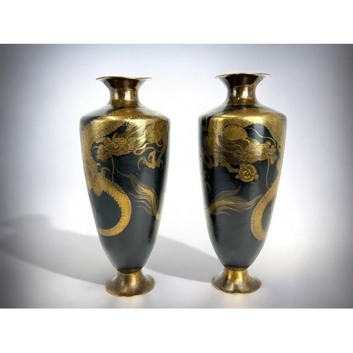 163 - A fine pair of Japanese bronze / brass 'Dragon' vases.Meiji period.Black ground, intricately etched ... 