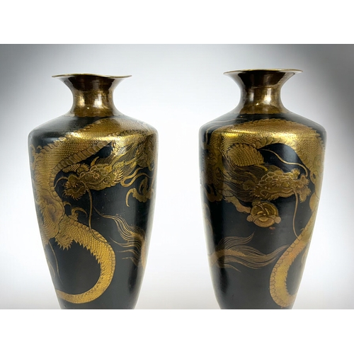 163 - A fine pair of Japanese bronze / brass 'Dragon' vases.Meiji period.Black ground, intricately etched ... 