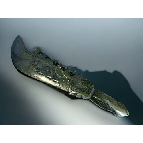 164 - A Chinese carved hardstone ceremonial dagger.Carved Dragons to each side with Taotie hilt. Length - ... 