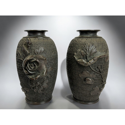 227 - A pair of Japanese bronze vases.Meiji period, 19th century.Finely detailed stylised ground, with hig... 