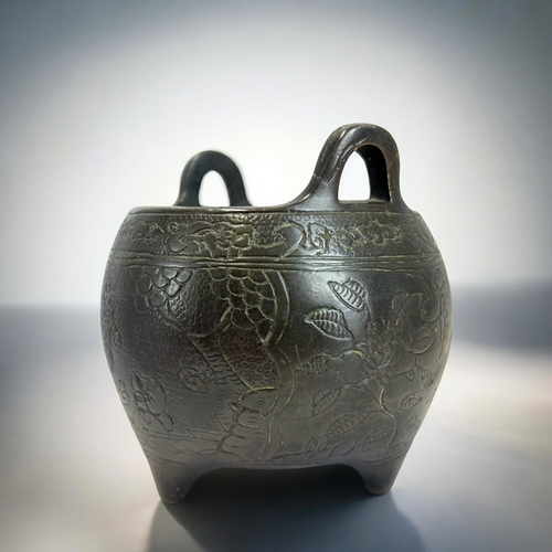 228 - A Chinese bronze tripod censer.Globular form, engraved with various scenes, including a warrior on h... 