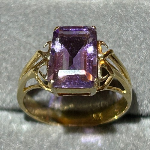 355 - A 10ct gold ring set with a large rectangular amethyst, approx UK size N, 2.6g