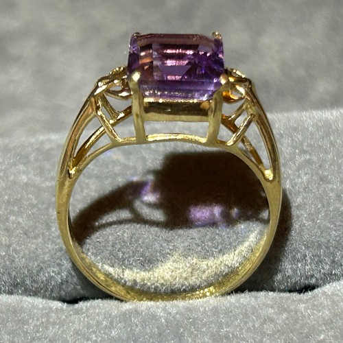 355 - A 10ct gold ring set with a large rectangular amethyst, approx UK size N, 2.6g