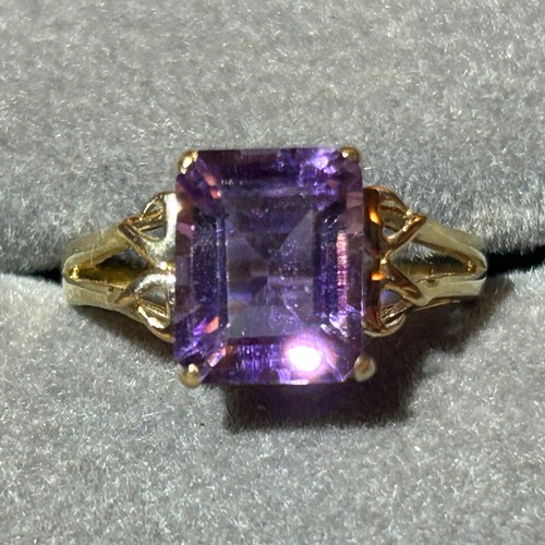 355 - A 10ct gold ring set with a large rectangular amethyst, approx UK size N, 2.6g