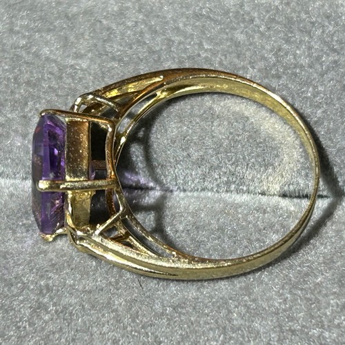 355 - A 10ct gold ring set with a large rectangular amethyst, approx UK size N, 2.6g