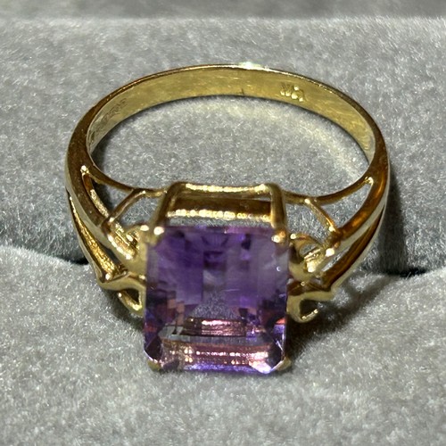 355 - A 10ct gold ring set with a large rectangular amethyst, approx UK size N, 2.6g