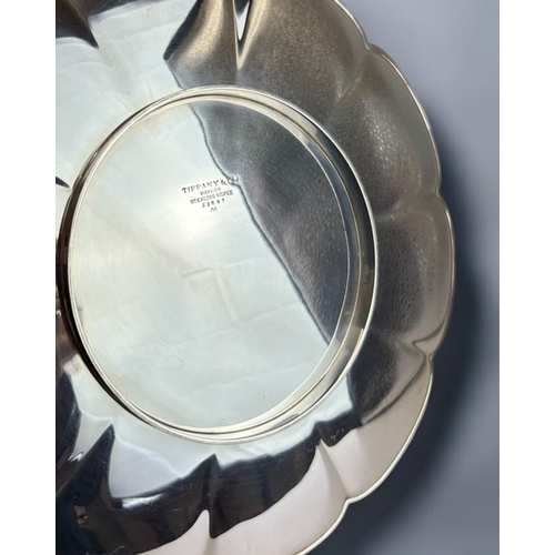 383 - A Tiffany & co sterling Silver salver.Scalloped edge, raised on short foot. Marked to base.Diame... 