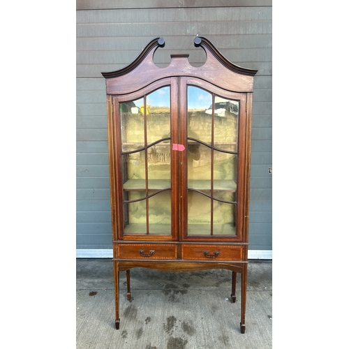 364 - Mahogany display cabinet with glass doors, curved pediment, and decorative inlay. Approximately 200 ... 