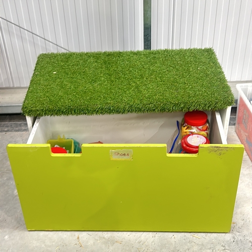 387 - Bright green storage box with artificial grass lid. Approximately 30 inches tall, 40 inches wide, an... 