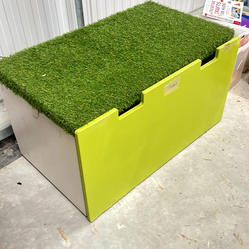 387 - Bright green storage box with artificial grass lid. Approximately 30 inches tall, 40 inches wide, an... 