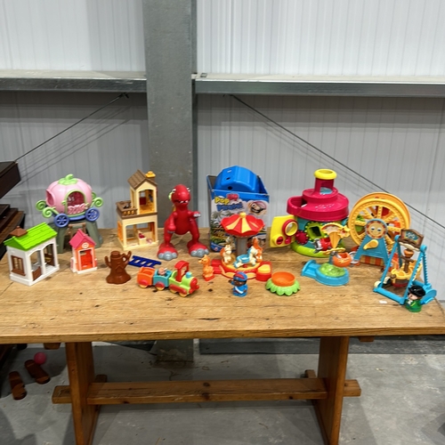 407 - Assorted plastic playset including carousel, dinosaur, train, and houses. Includes Pop-Up Pirate gam... 