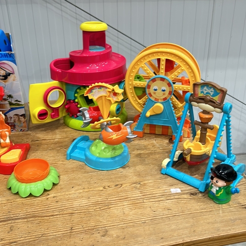 407 - Assorted plastic playset including carousel, dinosaur, train, and houses. Includes Pop-Up Pirate gam... 