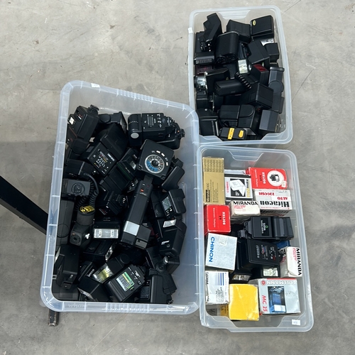 390 - Collection of vintage camera flash units, featuring brands like Miranda, Helios, and Chinon, among o... 