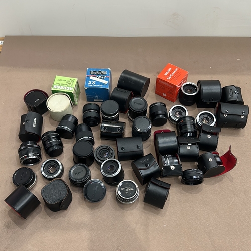 391 - Collection of vintage camera lenses and accessories, including Soligor, Teleplus, and Vivitar brands... 