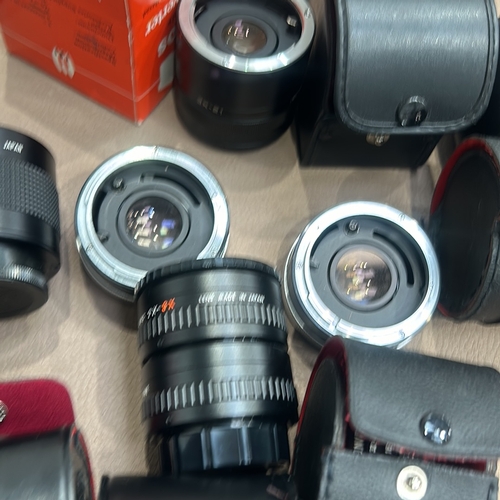 391 - Collection of vintage camera lenses and accessories, including Soligor, Teleplus, and Vivitar brands... 