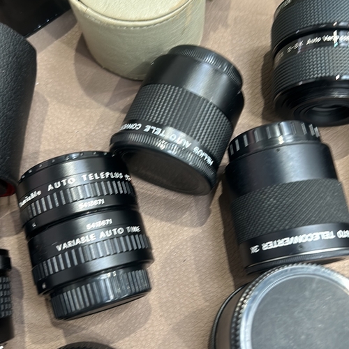 391 - Collection of vintage camera lenses and accessories, including Soligor, Teleplus, and Vivitar brands... 