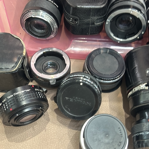 392 - Collection of vintage camera lenses, including Vivitar and Panagor brands, with storage cases. Assor... 