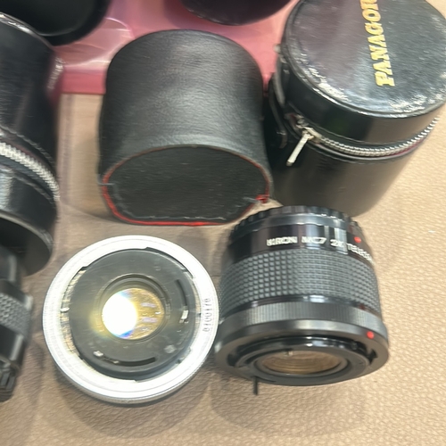 392 - Collection of vintage camera lenses, including Vivitar and Panagor brands, with storage cases. Assor... 