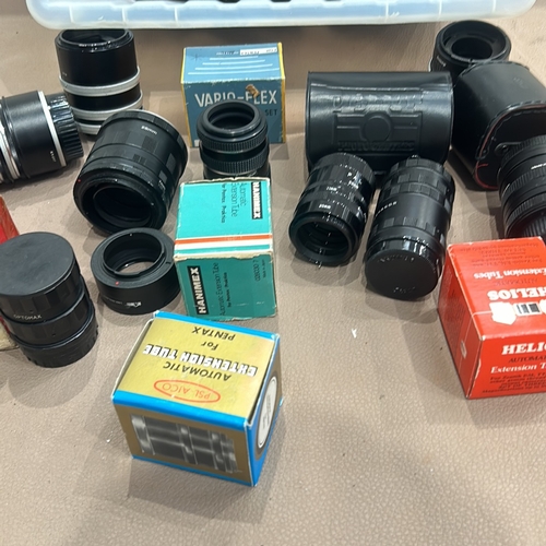 393 - Collection of vintage camera lenses and accessories, featuring brands like Tamron, Hanimex, and Heli... 