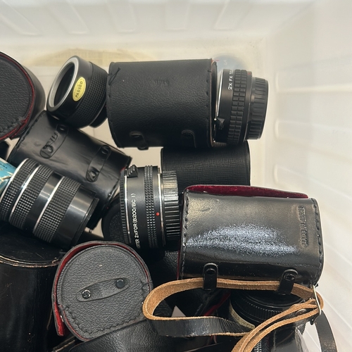 393 - Collection of vintage camera lenses and accessories, featuring brands like Tamron, Hanimex, and Heli... 