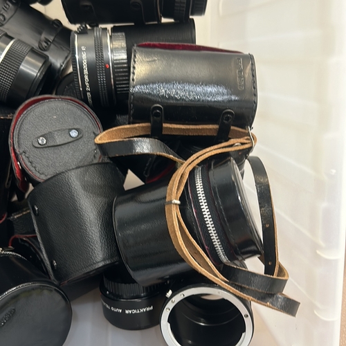 393 - Collection of vintage camera lenses and accessories, featuring brands like Tamron, Hanimex, and Heli... 