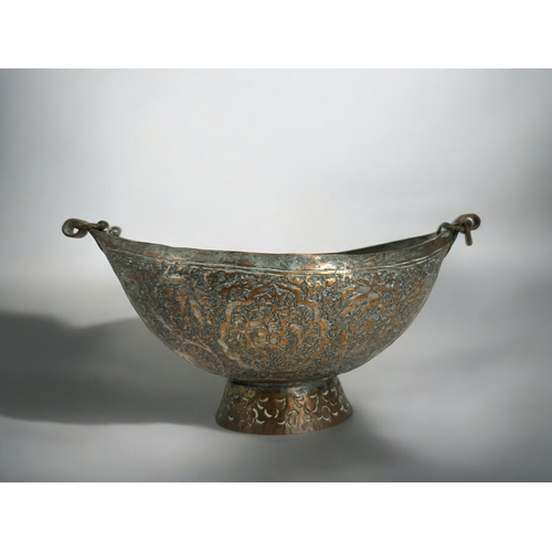 120A - A persian tinned copper 'Beggar's bowl' (Kashkul).18th-19th century.Engraved with stylised foliate d... 