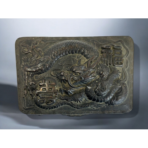 274 - A Chinese embossed metal trinket box.Early 20th century.Relief decorated with a entwined Dragon. Ins... 