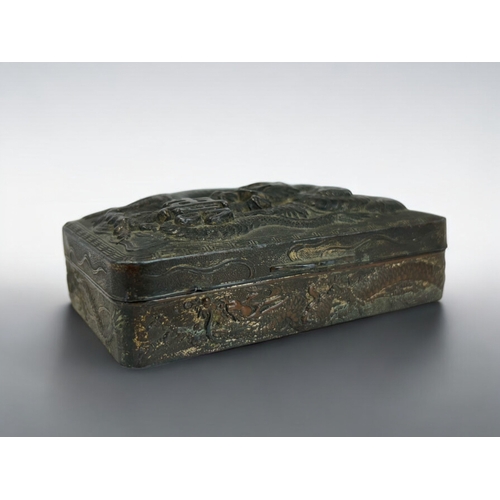 274 - A Chinese embossed metal trinket box.Early 20th century.Relief decorated with a entwined Dragon. Ins... 