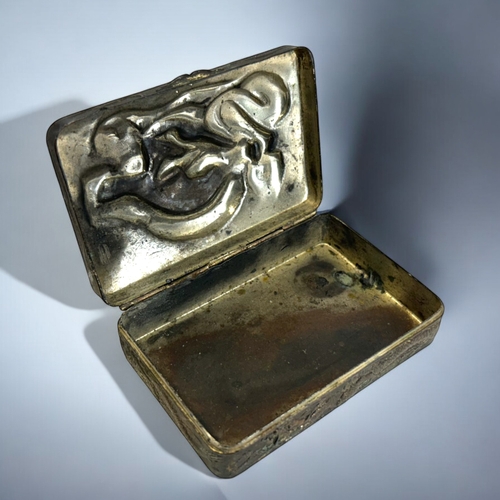 274 - A Chinese embossed metal trinket box.Early 20th century.Relief decorated with a entwined Dragon. Ins... 