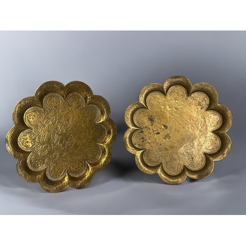 388 - Two antique Indian brass trays.Engraved designs, with scalloped edges. Diameter - 31cm