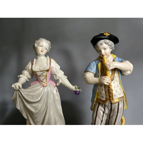 287 - A pair of German porcelain hand painted figures.Marks to base. Together with a Ernst Bohn seated fig... 