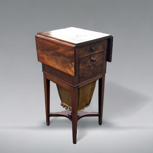 411 - A Regency period Walnut drop leaf work table.Single drawer and drop-front cupboard.