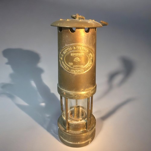 17 - Welsh Miners Lamp by E Thomas and Williams Ltd Cambrian No 5694, Brass Spitfire and a Bronze Bell.