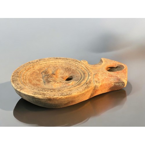 88 - 1st-2nd C Roman Disc Form oil lamp featuring Running Bear logo.9cm Length x 6.5cm Dia.