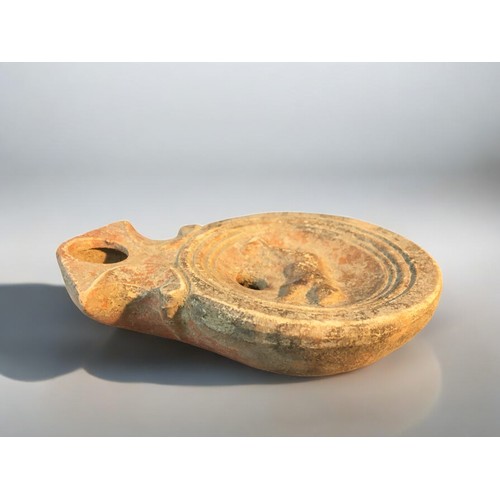 88 - 1st-2nd C Roman Disc Form oil lamp featuring Running Bear logo.9cm Length x 6.5cm Dia.