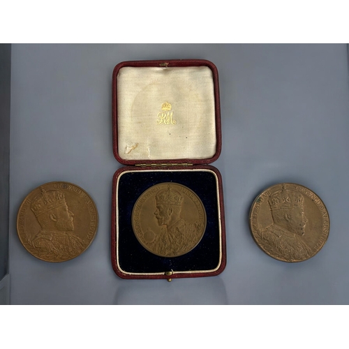 436 - A cased bronze official George V coronation medal.Together with two bronze Edward VII coronation med... 