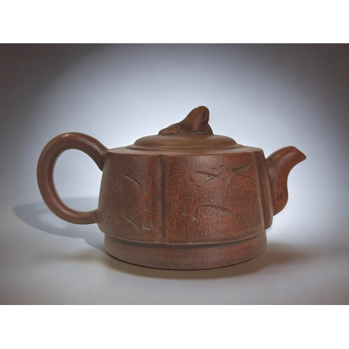 18 - A Chinese Yixing Zisha clay teapot.Incised script & foliate design.Marked to base. 18 x 9cm... 