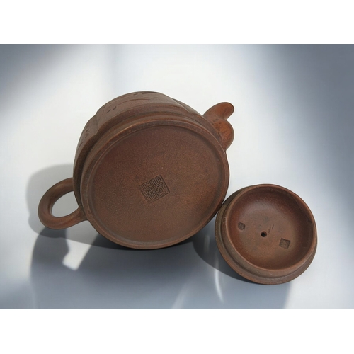 18 - A Chinese Yixing Zisha clay teapot.Incised script & foliate design.Marked to base. 18 x 9cm... 