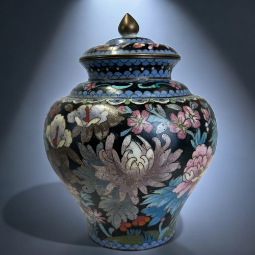 9 - A Chinese Cloisonné lidded jar.Qing dynasty.Squat form, intricately decorated with polychrome... 