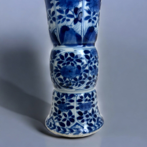 23 - A Chinese blue & white porcelain Gu vase.Kangxi period, (1662-1722). Gu form, painted panels of ... 