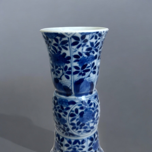 23 - A Chinese blue & white porcelain Gu vase.Kangxi period, (1662-1722). Gu form, painted panels of ... 