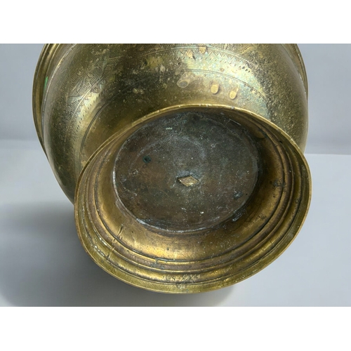 12 - A large cast brass Indonesian ceremonial bowl.Early 19th century, probably Java.Raised on tall foot,... 