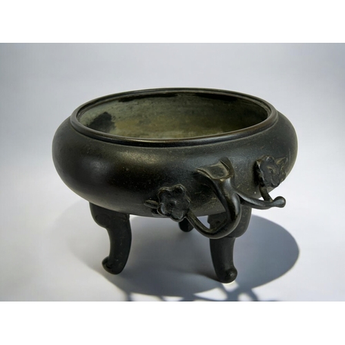 13 - A Japanese bronze tripod censer.Meiji period, 19th century.Raised on three feet, with Cherry blossom... 