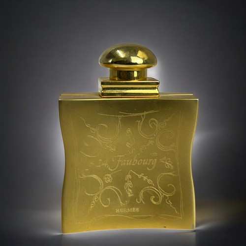 628 - A Hermes 24, Faubourg perfume holder.Together with an embroidered and engraved gilt metal clutch pur... 