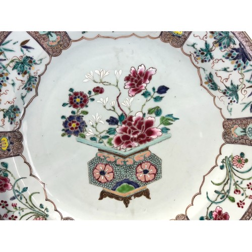 36 - A large Chinese porcelain Famille rose charger.Yongzheng/Qianlong, 18th Century.Enamels painted bask... 